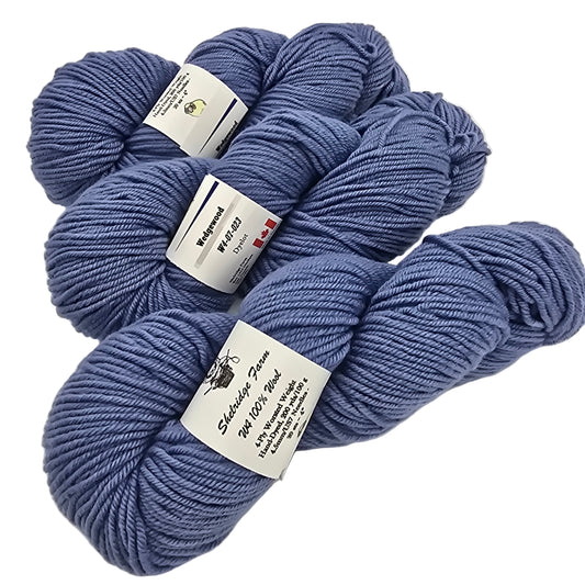 Three skeins of blue Shelridge farm in the color Wedgewood yarn with labels on a white background