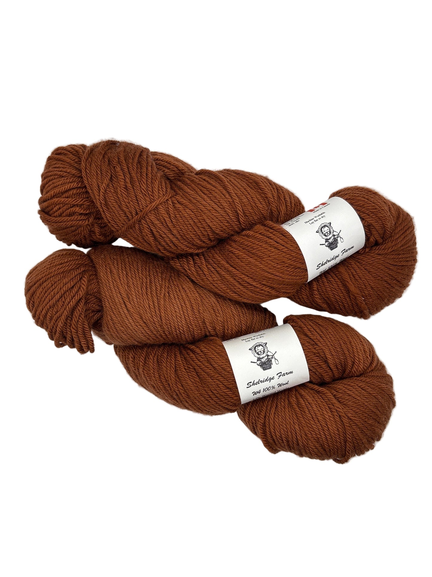 Two skeins of dark orange yarn with labels on a white background