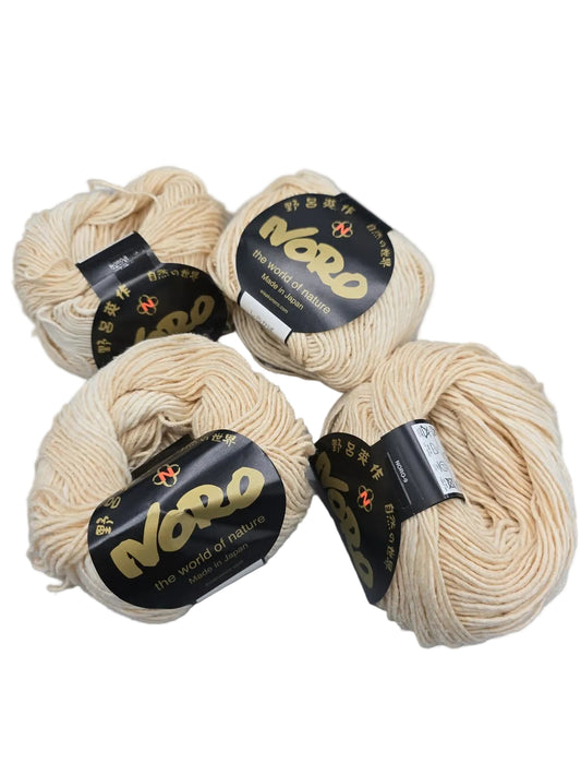 Image of 4 balls of Shirakaba Yarn by Noro with labels on a white background
