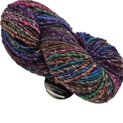 Image of a single skein of multicolor Iro by Noro Yarn in the color 16 with partial label showing on a white background.