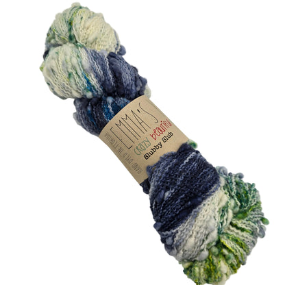Image of a single skein of Slubby Slub yarn by Emma's Yarn in the color Everglades with label on a white background.
