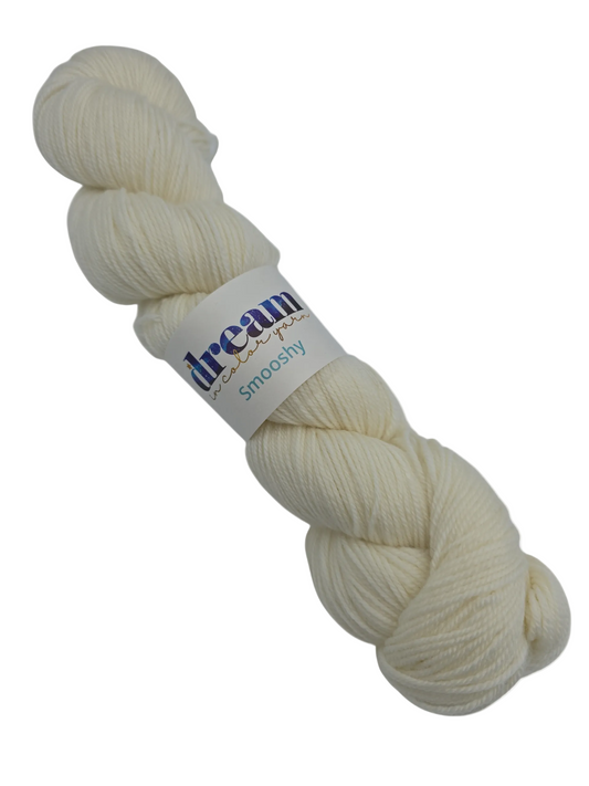 Image of a single skein of Smooshy by Dream in Color yarn in the color 01 Crying Dove with label on a white background.