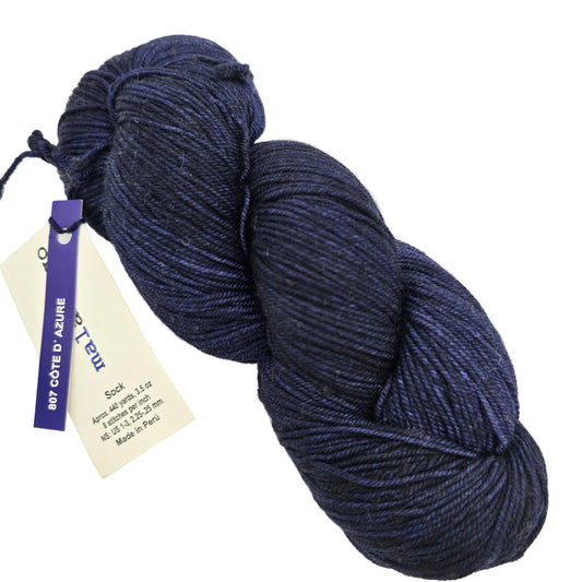 Image of a single skein of Sock by Malabrigo Yarn  in color 807 Cote de Azure with label on a white background.