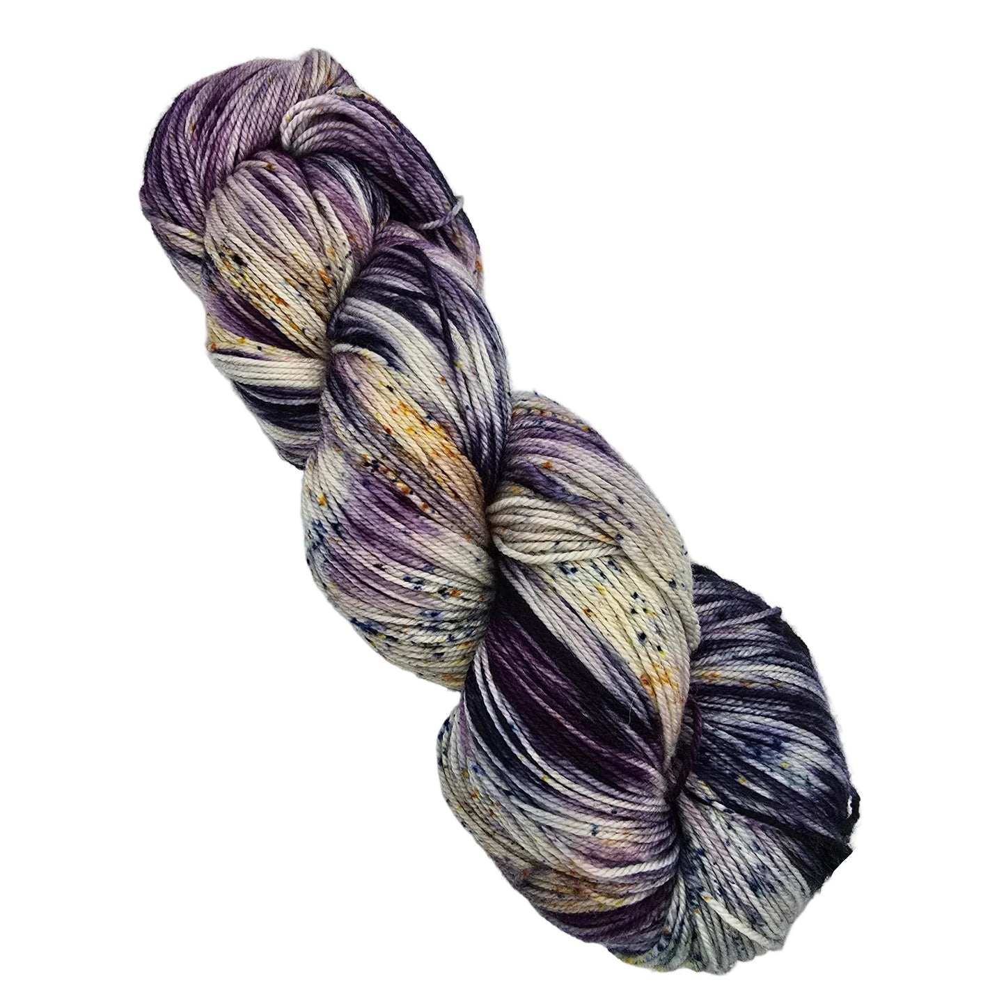 A single skein Sock by Malabrigo variegated yarn in a color called Ursula with purple, cream, gray, and gold flecks, photographed on a plain light gray background with a small product tag attached.