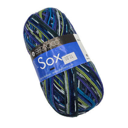 A single skein of Berroco Sox yarn in a variegated blue, purple, green, and black colorway, with a blue and black paper label, shown on a plain white background.