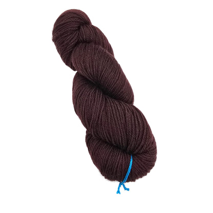 A skein of Springvale_DK_Yarn_by_Three_Irish_Girls_Yarn_Inc._in the color Tomahawk a solid brown on a white background.