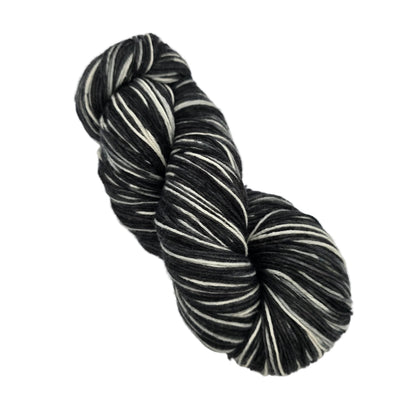 Image of a single skein of Stroll Hand Painted Yarn by Knit Picks in the color Knightly Hand Painted 27808 on a white background.