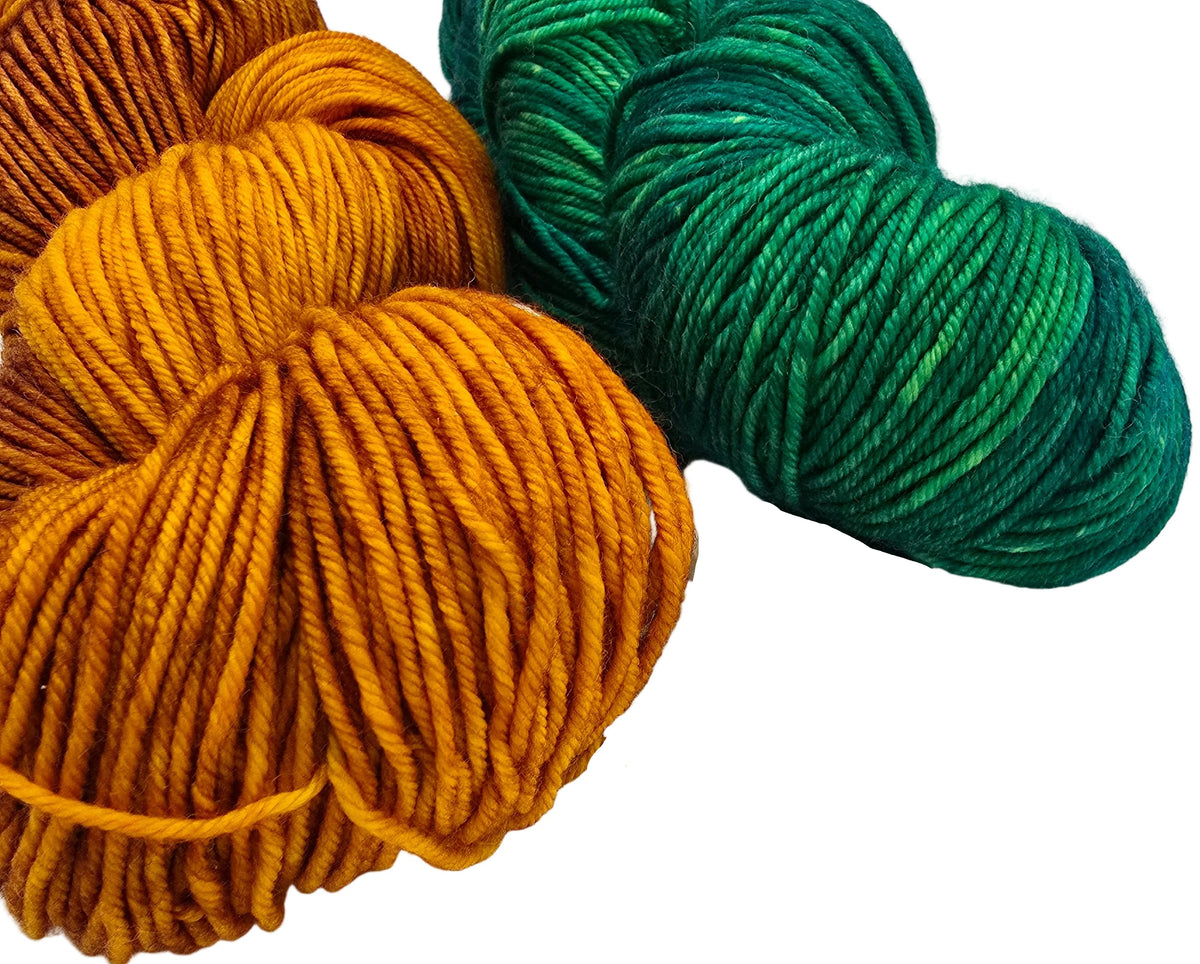 Two skeins of variegated yarn on a white background, one in mustard yellow and one in green.