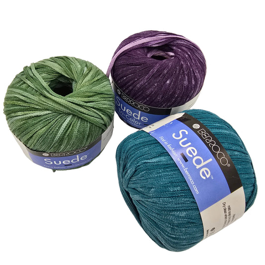 Image of three balls of Suede by Berroco yarn in various colors with labels on a white background.