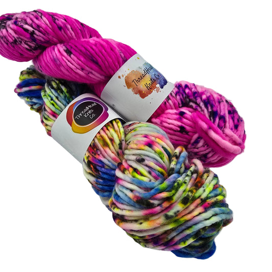 Image of two skeins of Super Bulky yarn by ThreadHead Knits Co. on a white background.