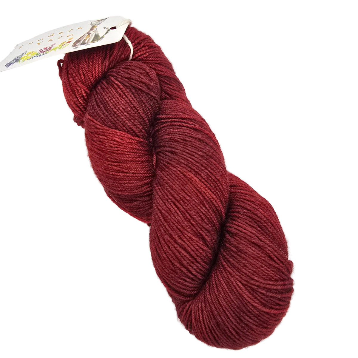 A skein of yarn in a deep burgundy red color, with a paper tag attached at one end, photographed on a clean white background.