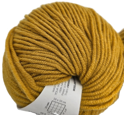 Close-up image of a ball of Super_Trouper_Wool_The_One_Merino_Wool_Yarn by_Wool_and_Gang_in the color_Mustard_Sally with partial label on a white background.