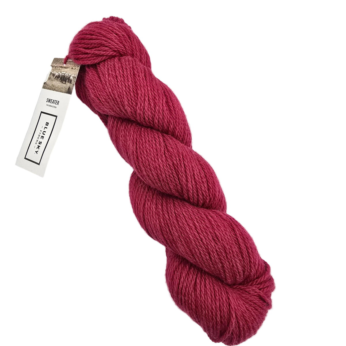 A skein of Sweater Worsted Yarn by Blue Sky Fibers in the color Popsicle a  bright pinkish red yarn with a paper label attached, photographed on a clean white background.