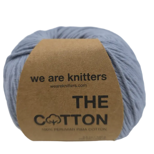 Image of a single ball of The Cotton yarn by We Are Knitters in Color 5146 Grey with label on a white background.