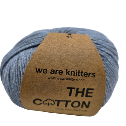 Image of a single ball of The Cotton Yarn by We Are Knitters in Denim with label on a white background.