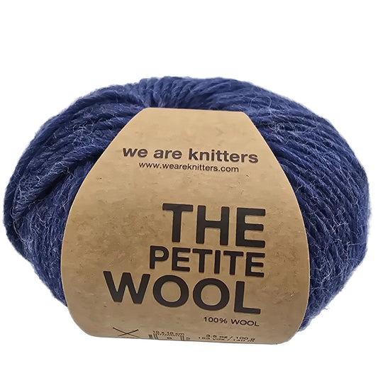 Image of a single ball of The Petite Wool yarn by We Are Knitters with label on a white background.