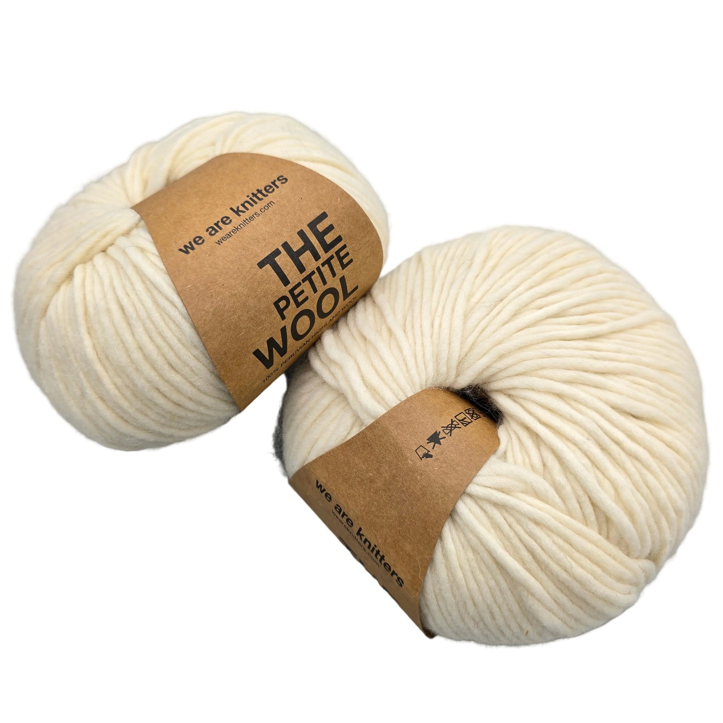 Image of two balls of The Petite Wool - We Are Knitters yarn in the color Natural with labels on a white background.