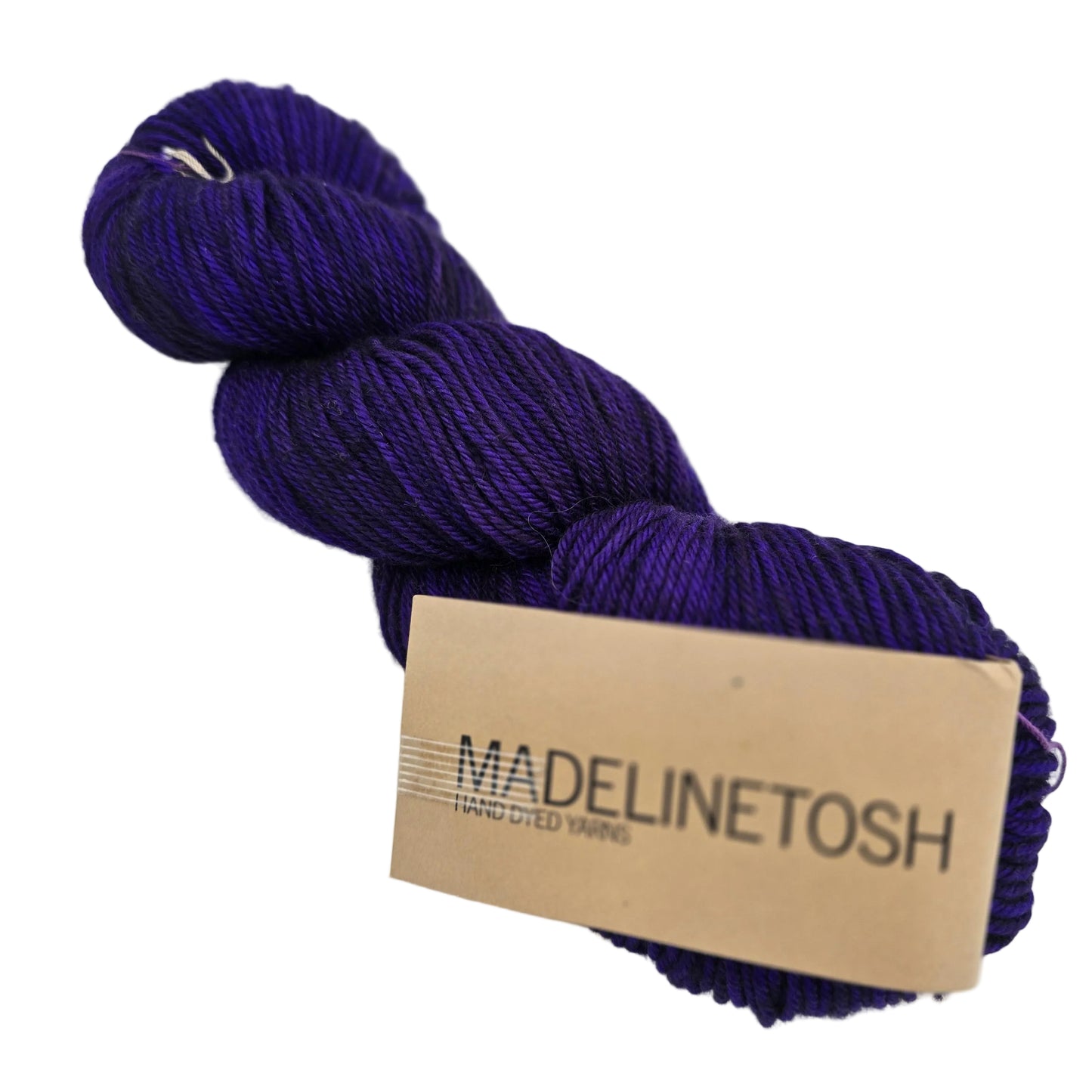 A skein of Tosh_DK_yarn by_Madelinetosh_in the color Himiko_a deep purple with label on a white background.