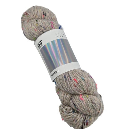 Image of a single skein of Tweedy Yarn by Hedgehog Fibres in the color Natural with label on a white background.