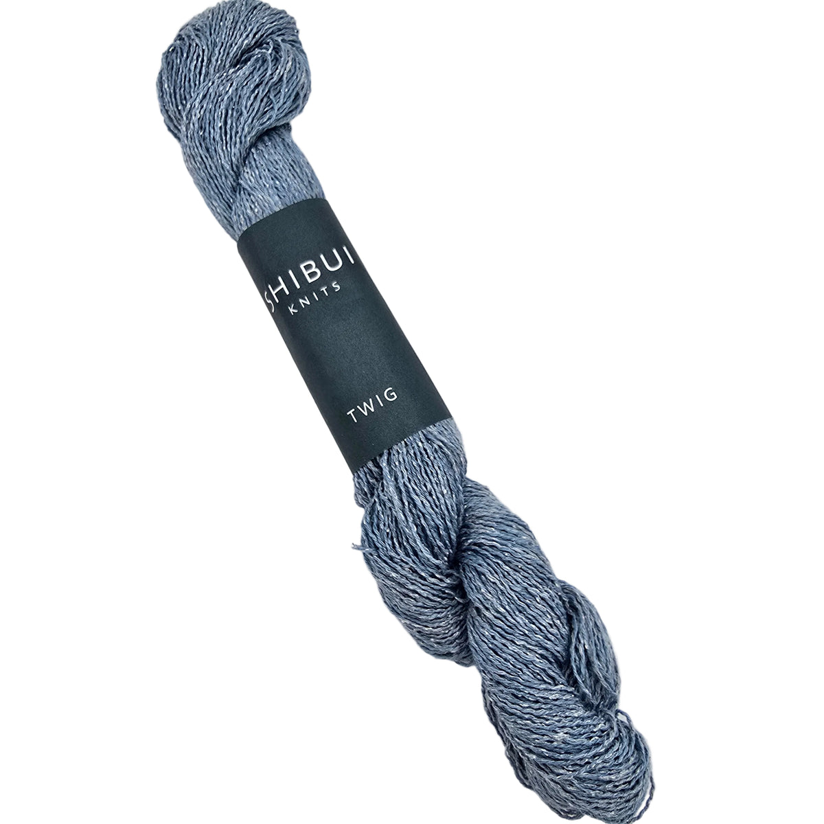 A skein of Shibumi Knits 'Twig' yarn in "shore" color 2182, a heathered blue and gray marled texture, wrapped in a dark gray paper band label on white background.