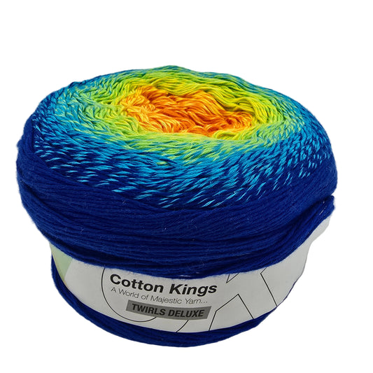 A ball of Cotton Kings Twirls Deluxe yarn in color 13 Andamooka Opal showing a vibrant colorwork gradient of blue, yellow, and orange, with a white paper label wrapped around the base.