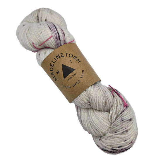 Image of a single hank of Twist Light yarn by Madelinetosh  in the color Good Silence with label on a white background.