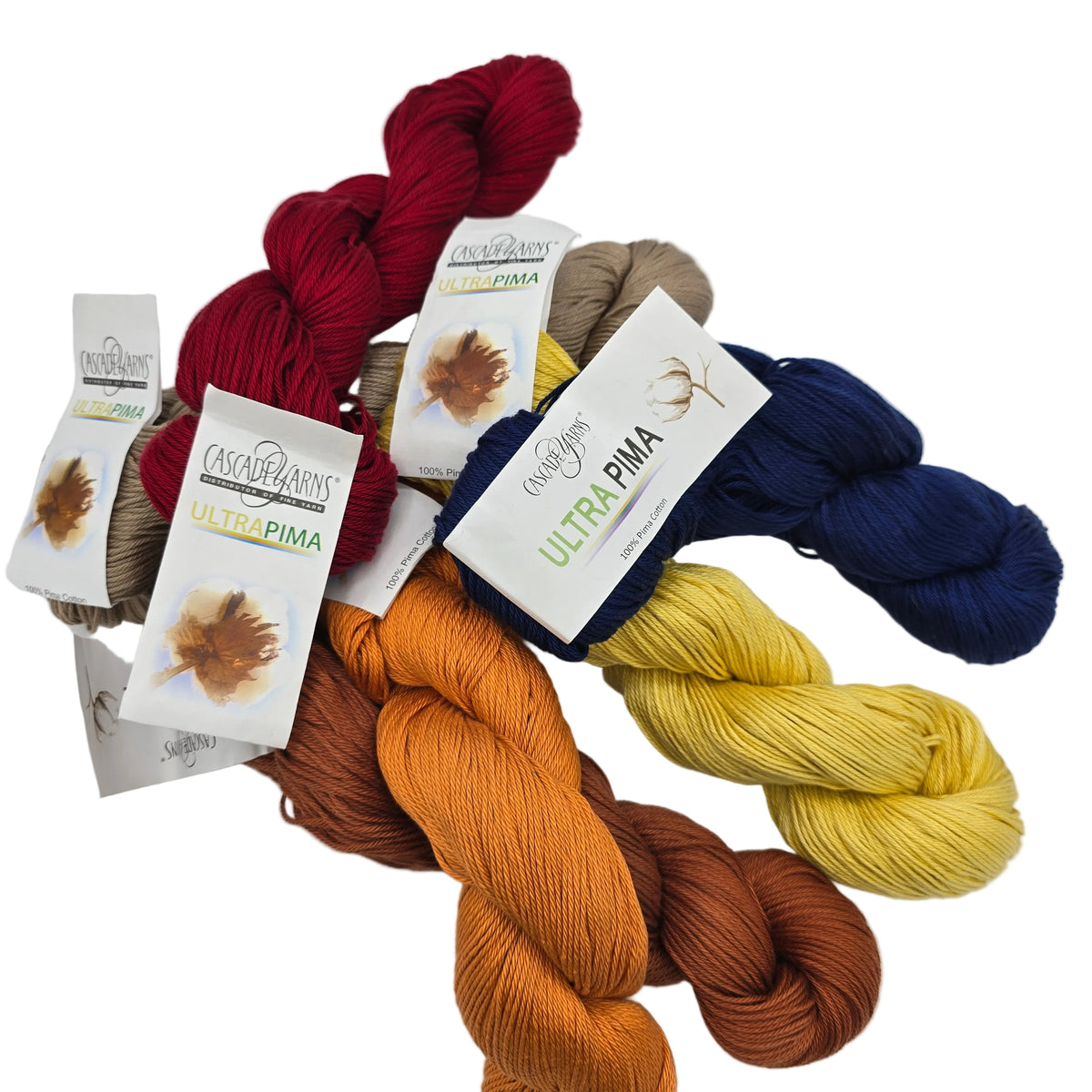 Image of multiple skeins of Ultra Pima Yarn by Cascade with labels on a white background.