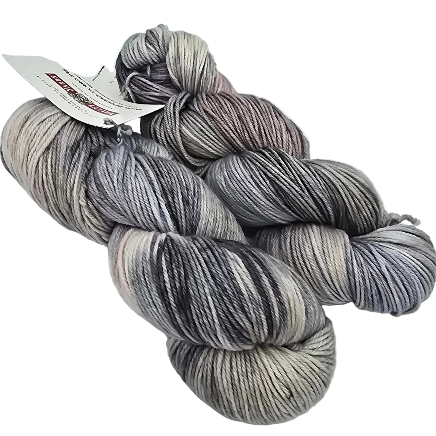 two skeins of color number 2, Fog valley superwash DK yarn by manos del Uruguay and Valley Yarns on a white background with label.