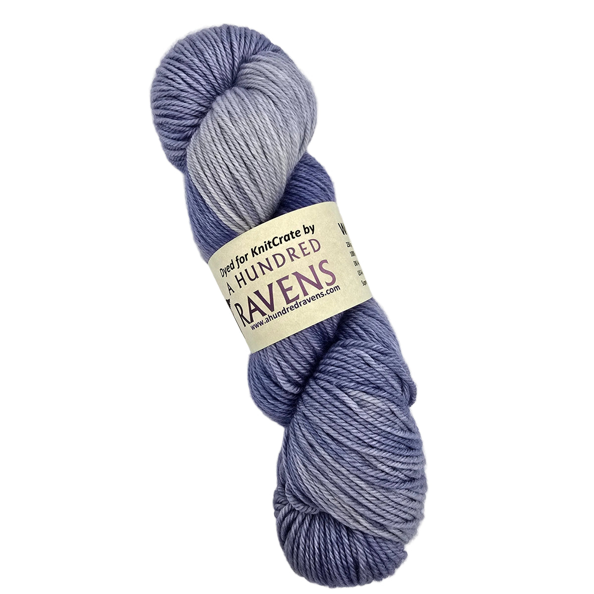 A skein of variegated yarn in shades of periwinkle, lavender, and light blue-gray, wrapped with a paper label on a white background.