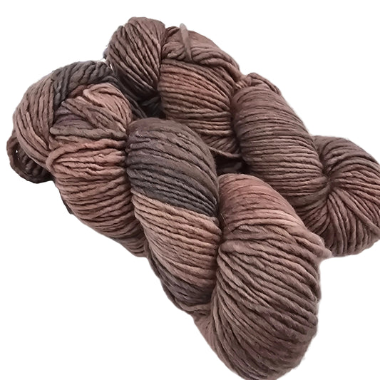 Image of two skeins of Worsted by Malabrigo Yarn in color 74 Polvoriento on a white background.