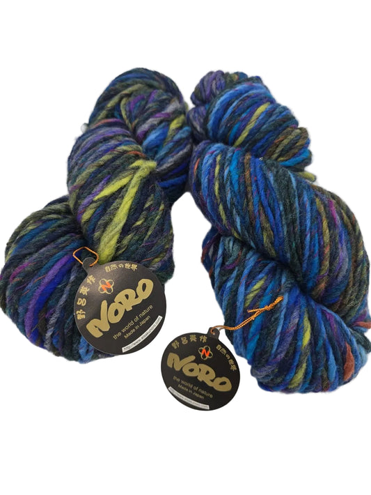 Image of two skeins of Yoroi by Noro in Color 4, with label on white background