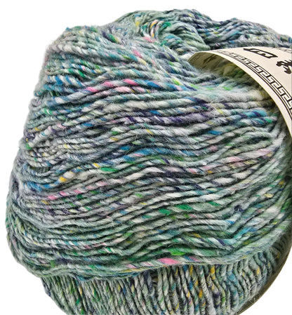 A close-up of a variegated yarn ball with a cream paper label, showing a blend of mint green, blue, purple, and white fibers, on a white background.