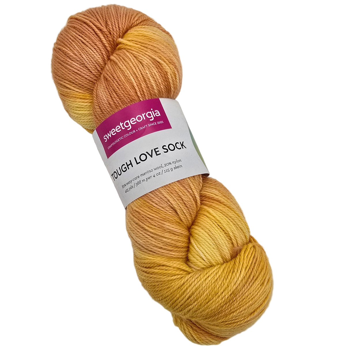 A skein of Sweet Georgia Yarn's 'Tough Love Sock' in a variegated colorway of mustard yellow, golden orange, and peach. The yarn is wrapped with a paper label showing the brand 'sweetgeorgia' and product name 'TOUGH LOVE SOCK'.