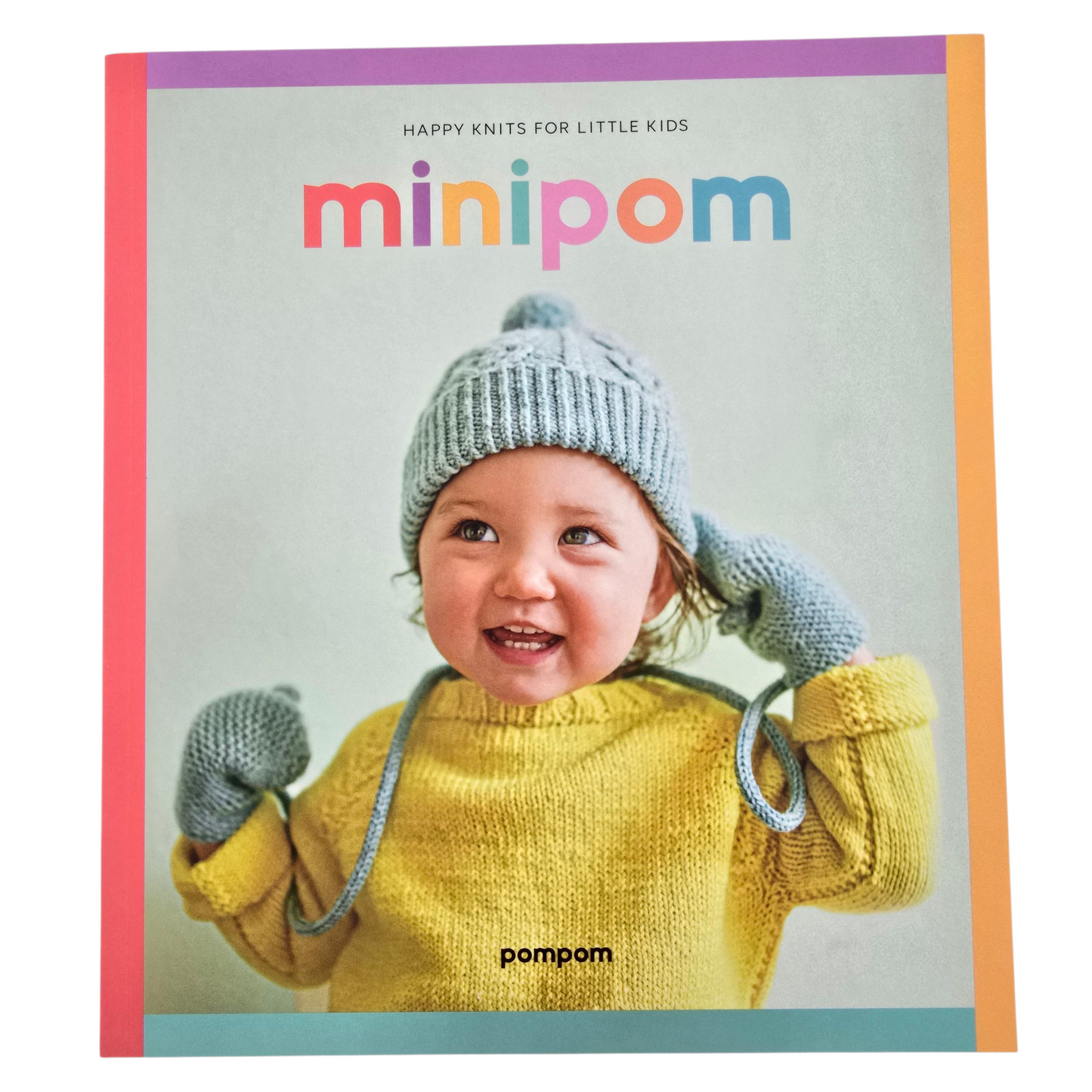 Image of a book with child on the cover wearing a yellow knit sweater and matching blue knit  hat and mittens on a white background.